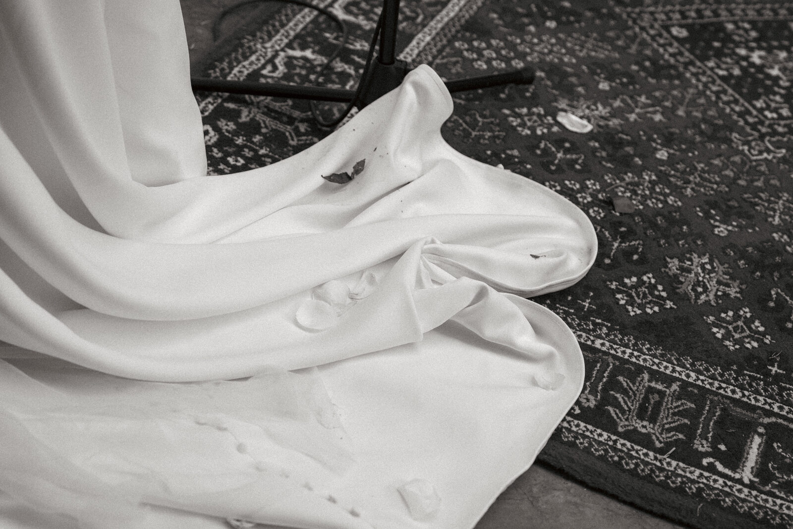 Wedding dress draped on the floor after the ceremony