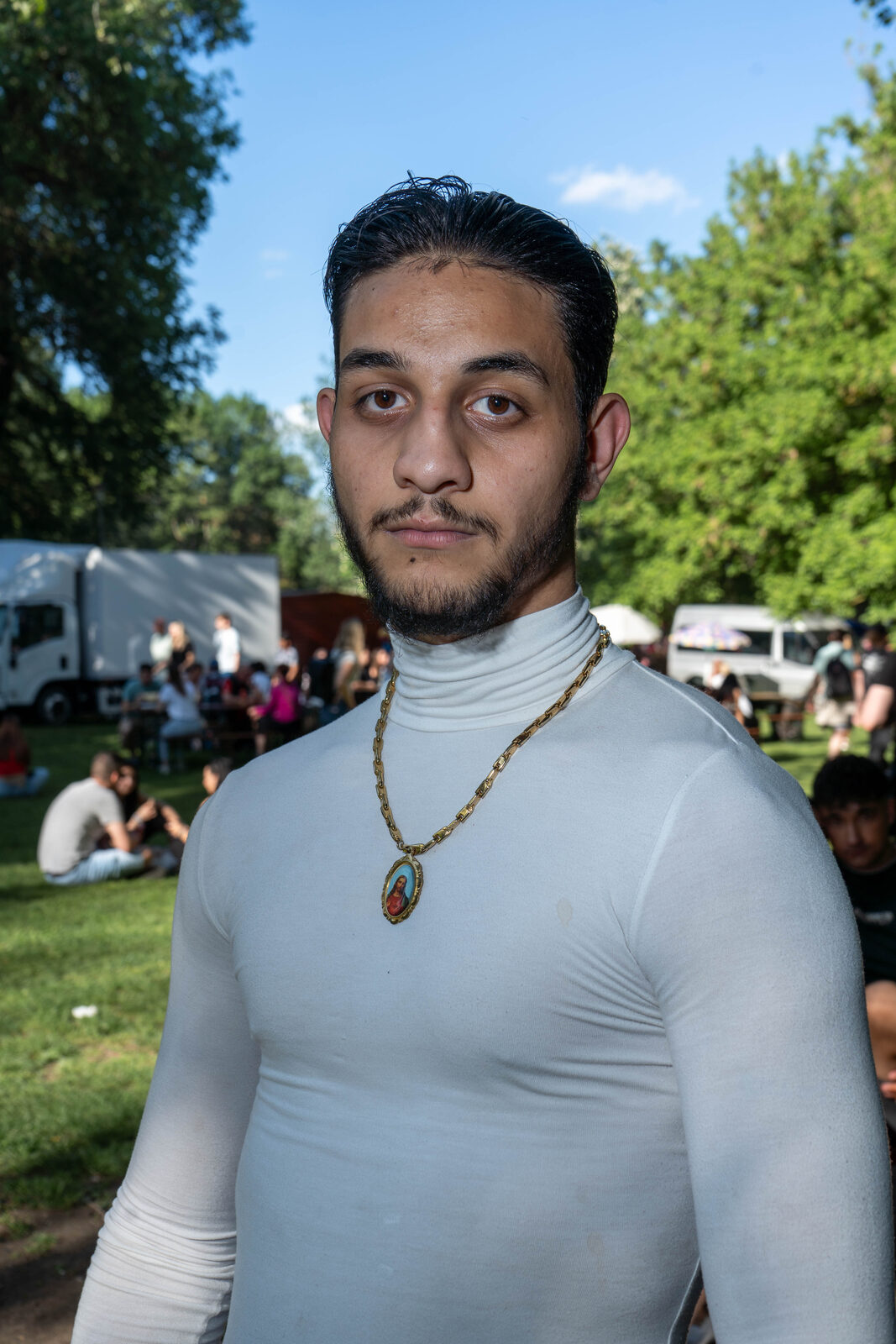 Young man in a turtleneck with a gold pendant necklace